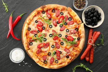 Tasty pizza and ingredients on grey table, top view