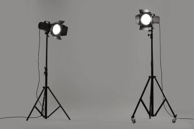 Stüdyoda gri fotoğraf ve profesyonel ışıklandırma ekipmanları