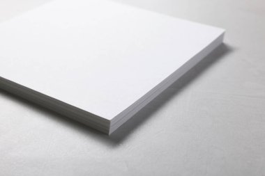Gri desenli masa üzerindeki boş kağıt çarşaflar, yakın plan. Tasarım için model