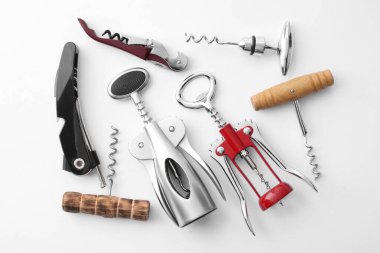 Different corkscrews on white background, flat lay clipart