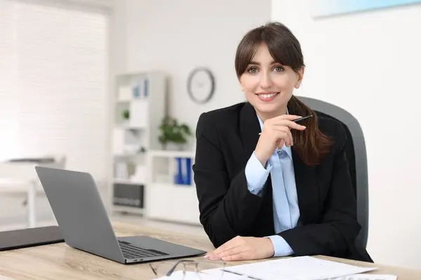 stock image Portrait of smiling secretary at table in office