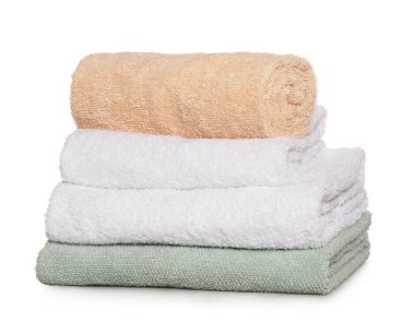 Soft colorful terry towels on light table against white background