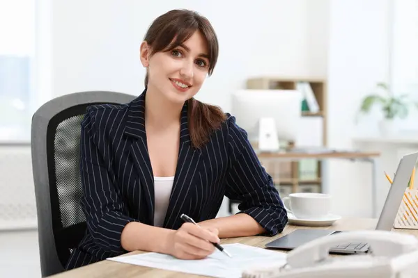 Stock image Portrait of smiling secretary at table in office