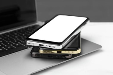 Stack of electronic devices on white table