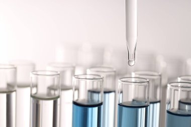 Işık arka planında pipetten test tüpüne sıvı damlatılıyor, yakın plan