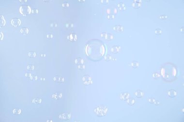 Açık gri arkaplanda güzel şeffaf sabun köpükleri