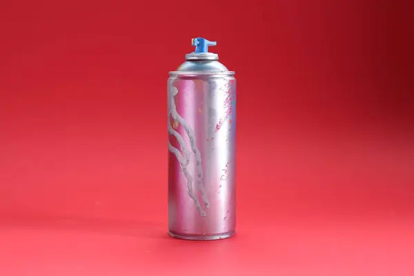 stock image One can of bright spray paint on red background