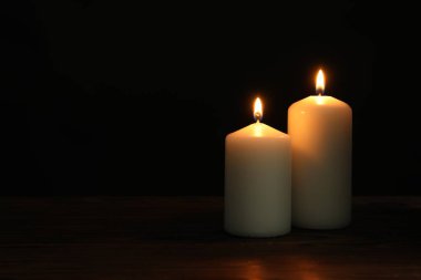 Siyah arka planda yanan iki kilise mumu, metin için alan