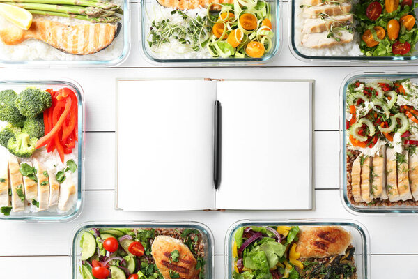 Healthy meal. Open notebook and containers with different products on white wooden table, flat lay