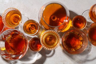 Açık gri masadaki bardaklarda farklı lezzetli içkiler, düz yatış.