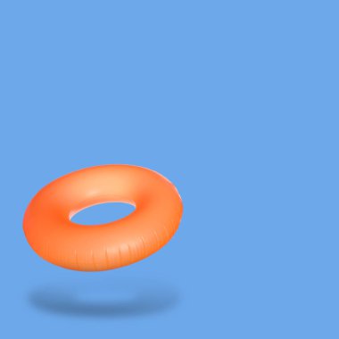 Mavi arka planda turuncu şişirilebilir halka. Metin için boşluk