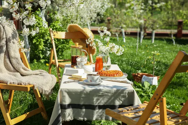 stock image Beautiful table setting with spring flowers in garden on sunny day