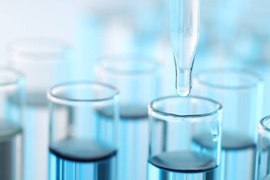 Işık arka planında pipetten test tüpüne sıvı damlatılıyor, yakın plan