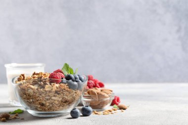 Böğürtlenli, fındıklı ve gri masada nane aromalı granola. Metin için boşluk