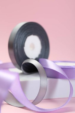 Kurdele, pembe arkaplanda farklı renkte makaralar, yakın plan görünümü