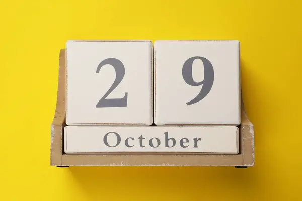 Stock image International Psoriasis Day - 29th of October. Block calendar on yellow background, top view