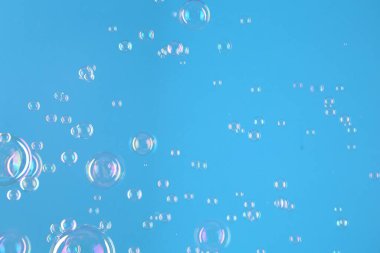 Açık mavi arkaplanda güzel şeffaf sabun köpükleri