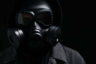 Siyah arka planda gaz maskeli adam, yakın plan.