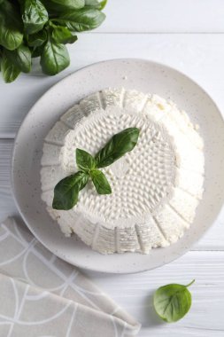 Lezzetli ricotta (krem peynir) ve fesleğen beyaz ahşap masa, düz yatıyordu