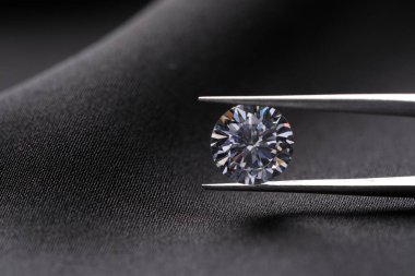 Cımbızla siyah kumaş üzerinde pırlanta renginde güzel elmaslar, yakın plan. Metin için boşluk