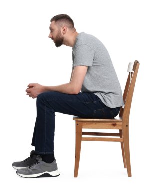 Man with poor posture sitting on chair against white background clipart