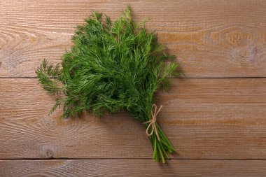 Tahta masada taze dereotları var.