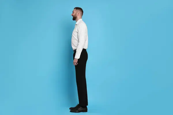 stock image Man with good posture on light blue background