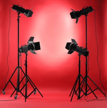 Stüdyoda kırmızı fotoğraf ve profesyonel ışıklandırma ekipmanları