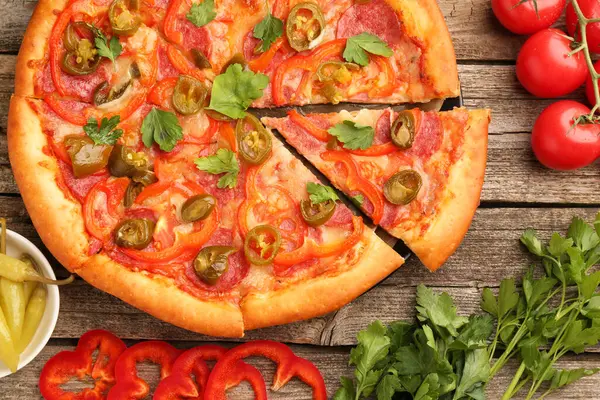 stock image Delicious pizza Diablo and ingredients on wooden table, flat lay