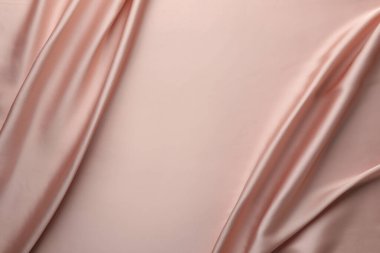 Arka plan olarak buruşuk pembe ipek kumaş, üst manzara. Metin için boşluk