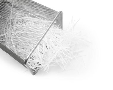 Metal basket and shredded paper isolated on white, above view clipart