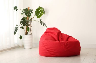 Red bean bag chair on floor in room