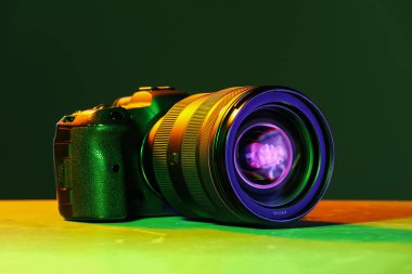 Masanın üzerinde neon ışıklı modern fotoğraf makinesi var.