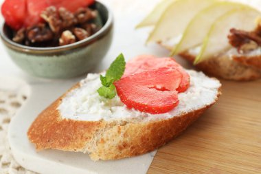 Taze ricotta (krem peynir) ile nefis bruschetta, masada çilek ve nane, yakın plan