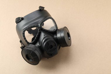 Bej arka planda bir gaz maskesi, mesaj için boşluk. Güvenlik ekipmanları