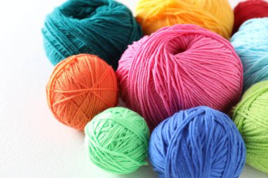 Açık gri arkaplanda pek çok yumuşak iplik yumağı, yakın plan