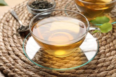 Hasır hasırın üzerinde yeşil çayı tazeliyorum, yakın plan.