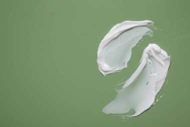 Yeşil arka planda yüz kremi, üst manzara. Metin için boşluk