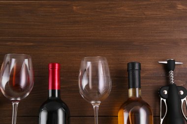 Kanat tirbuşonu ve ahşap masada şarap bulunan düz bir kompozisyon. Metin için boşluk