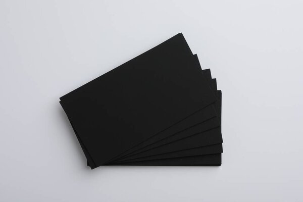 Blank business cards on light grey background, top view. Mockup for design