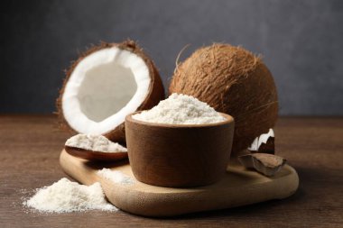 Tabakta organik hindistan cevizi unu, kaşık ve ahşap masada taze meyveler.