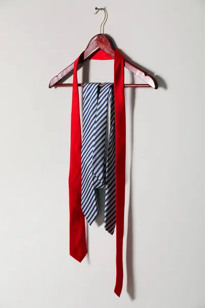 stock image Hanger with different stylish neckties on light wall