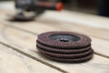 Many grinding wheels on wooden table, closeup