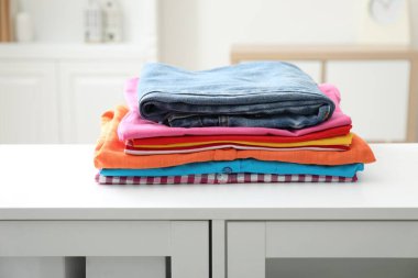 İçerideki beyaz şifoniyere temiz giysiler yığılmış.