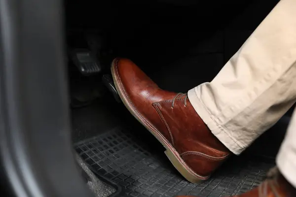 stock image Man pushing on pedal of car brake, closeup