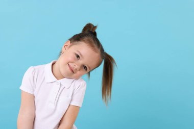 Açık mavi arka planda şirin küçük bir kızın portresi, metin için boşluk