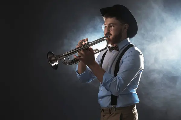 stock image Professional musician playing trumpet on dark background with smoke