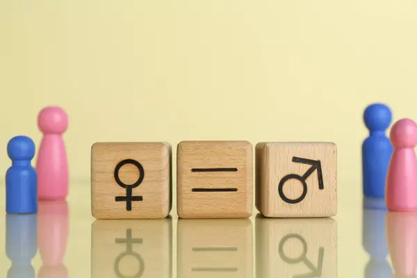 stock image Gender equality concept. Wooden cubes with male and female symbols on light yellow background