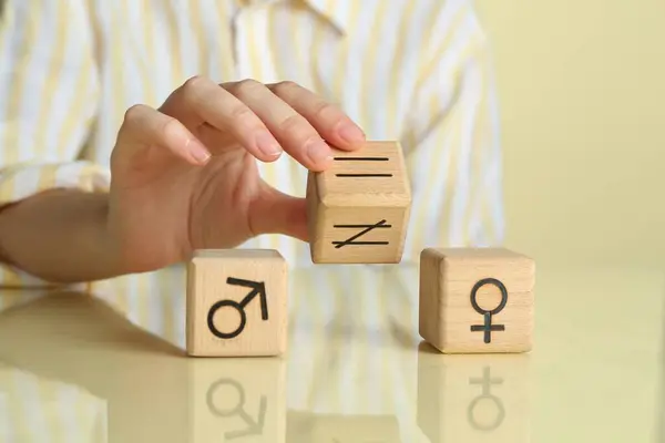 stock image Gender equality concept. Woman with wooden cubes of male and female symbols at table, closeup