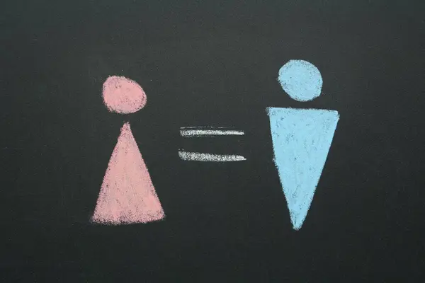 stock image Gender equality concept. Male and female figures drawn on chalkboard, top view